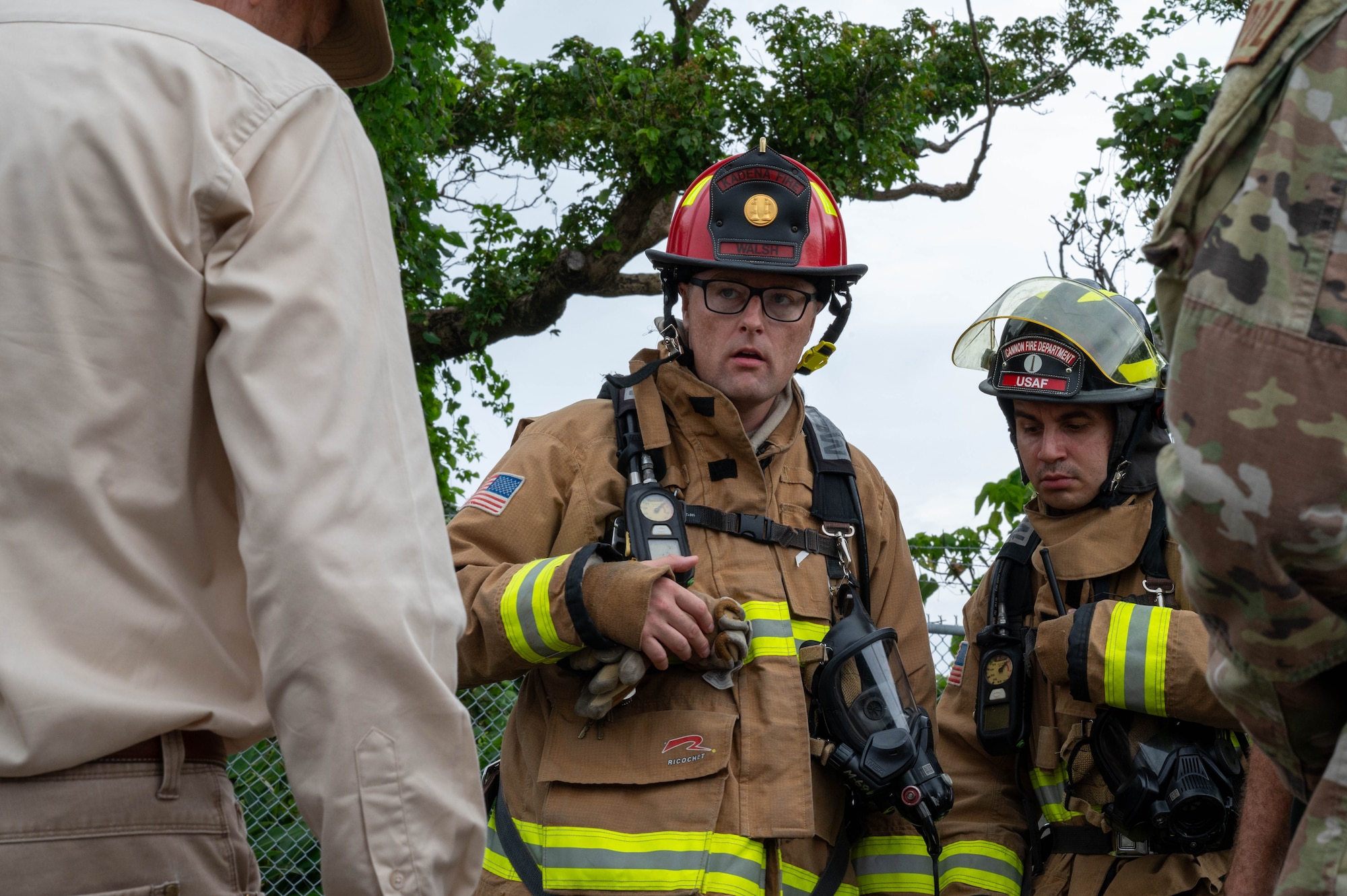 Airmen brief a response team during a spill training scenario.