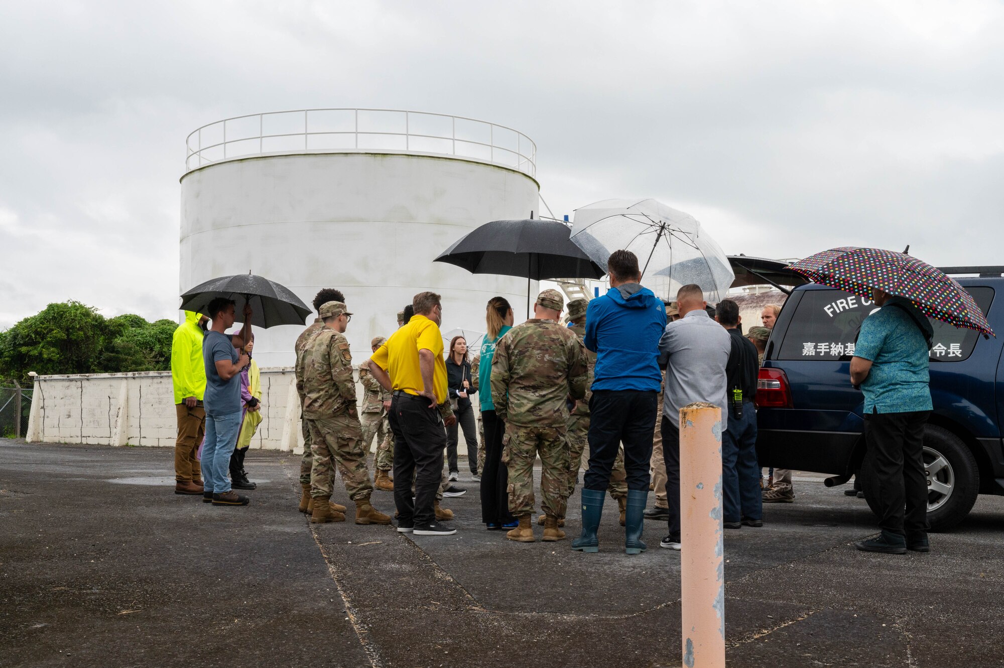 Airmen and contractors discuss a training scenario.