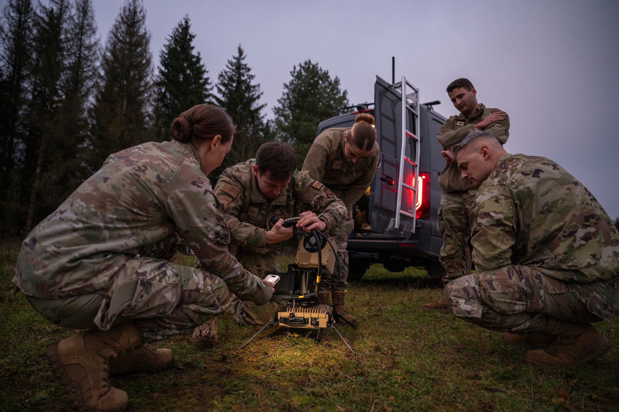 U.S. Air Force Senior Airman Lance Smith, center, 1st Combat Communications Squadron tactical communications technician, sets up a PANTHER 2, Very Small Aperture Terminal (VSAT) satellite at Hohenfels Joint Multinational Readiness Center, Germany, Oct. 28, 2024.