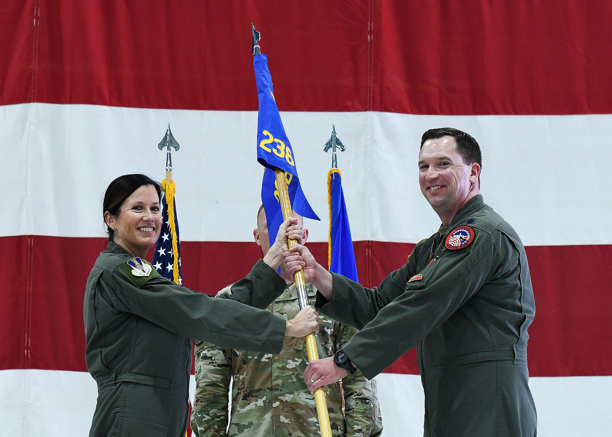 Air Force Colonel passes 238th RS guidon to a Lieutenant Colonel