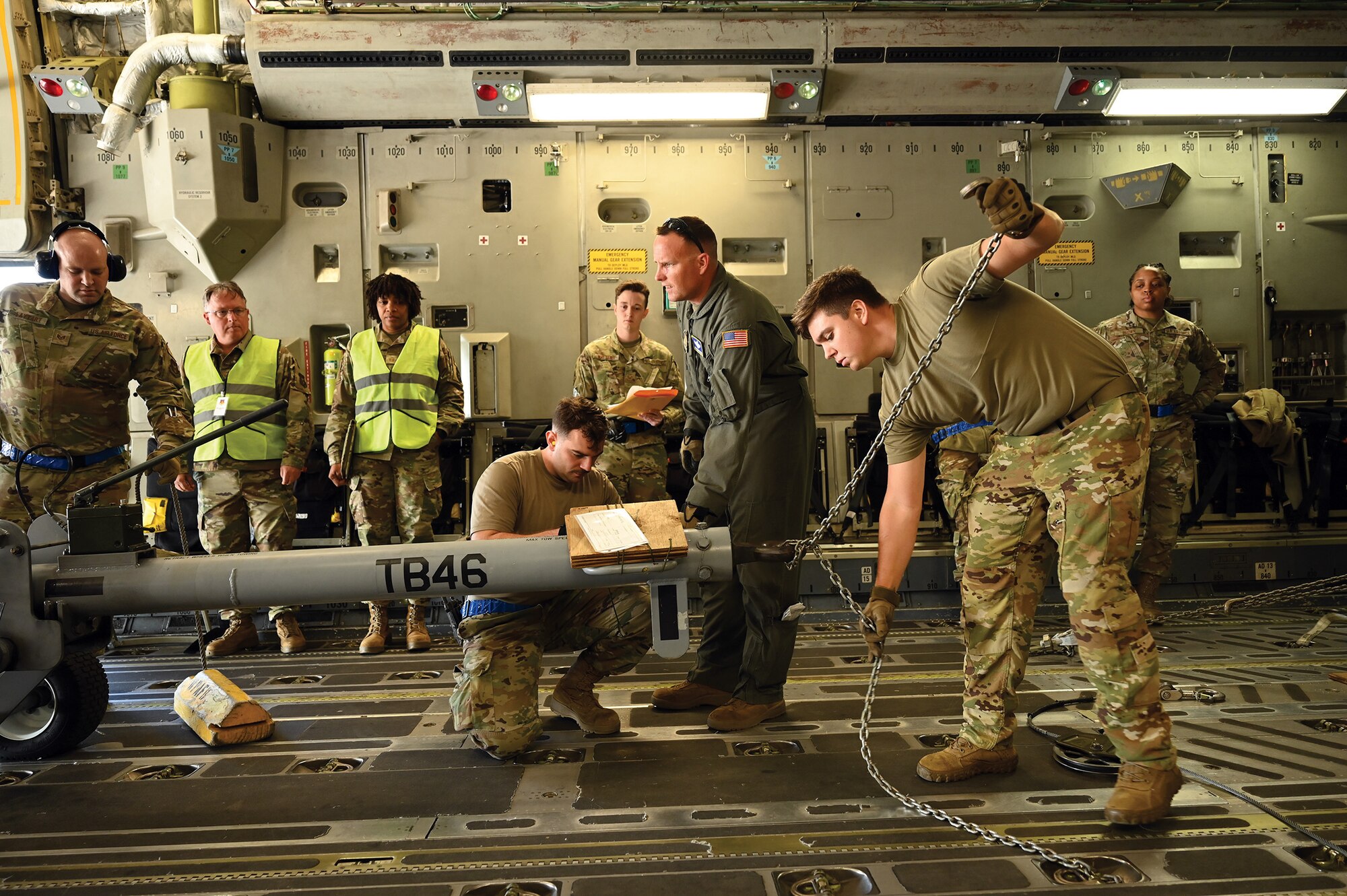 Senior Airman Stanley Fairchild III, right, 89th Airlift Squadron loadmaster, secures a tow bar onto a C-17 Globemaster III aircraft prior to takeoff during exercise Vigilant Elk at Wright-Patterson Air Force Base, Ohio, Oct. 6, 2024. (U.S. Air Force photo/Master Sgt. Patrick O’Reilly)