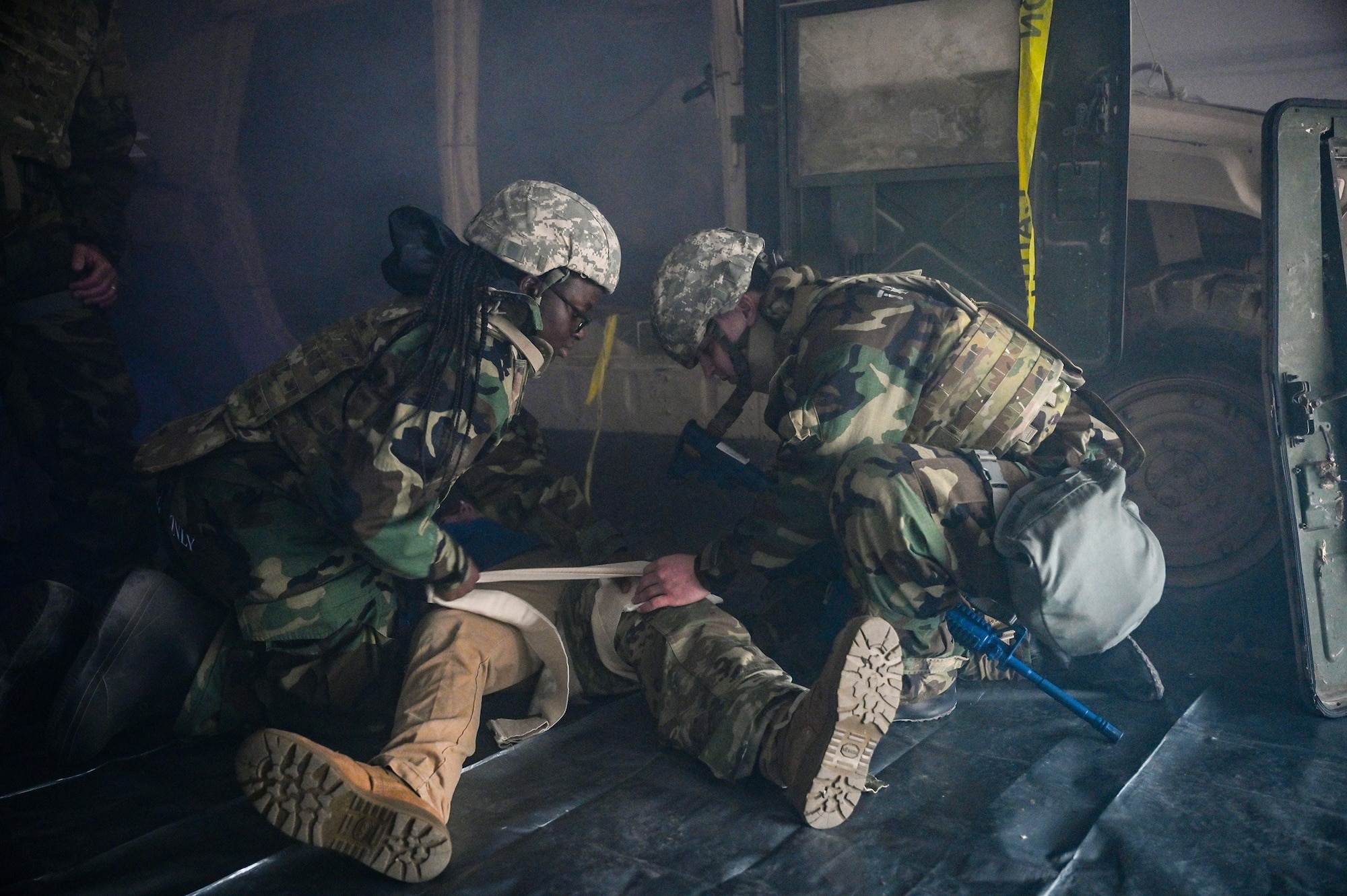 Airman Gracia Halimoya-Musa, left 445th Force Support Squadron fitness assessment cell specialist, and Senior Airman Samuel Shaffer, 445th FSS services journeyman, provide tactical combat casualty care to a simulated patient during exercise Vigilant Elk at the Warfighter Training Center at Wright-Patterson Air Force Base, Ohio, Oct. 7, 2024.