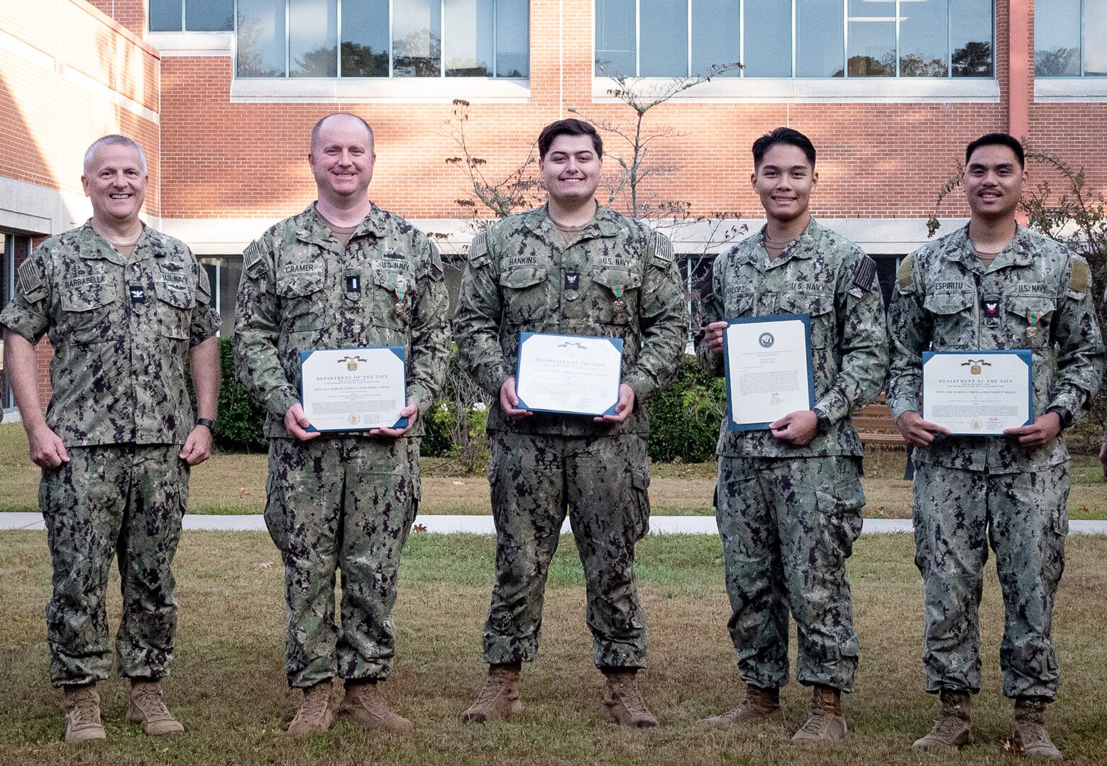 Sailors and civilians serving aboard Naval Health Clinic Cherry Point celebrated the accomplishments of their peers Wednesday, October 30, 2024, during an awards ceremony.
Recognized were, from left to right, Lieutenant Junior Grade James Cramer and Hospital Corpsman Brandon Hankins, both awarded the Navy and Marine Corps Achievement Medal, Hospital Corpsman Fernan Elijah Valdez with a Letter of Commendation and Hospital Corpsman Second Class Ernest Espiritu with the Navy and Marine Corps Achievement Medal.