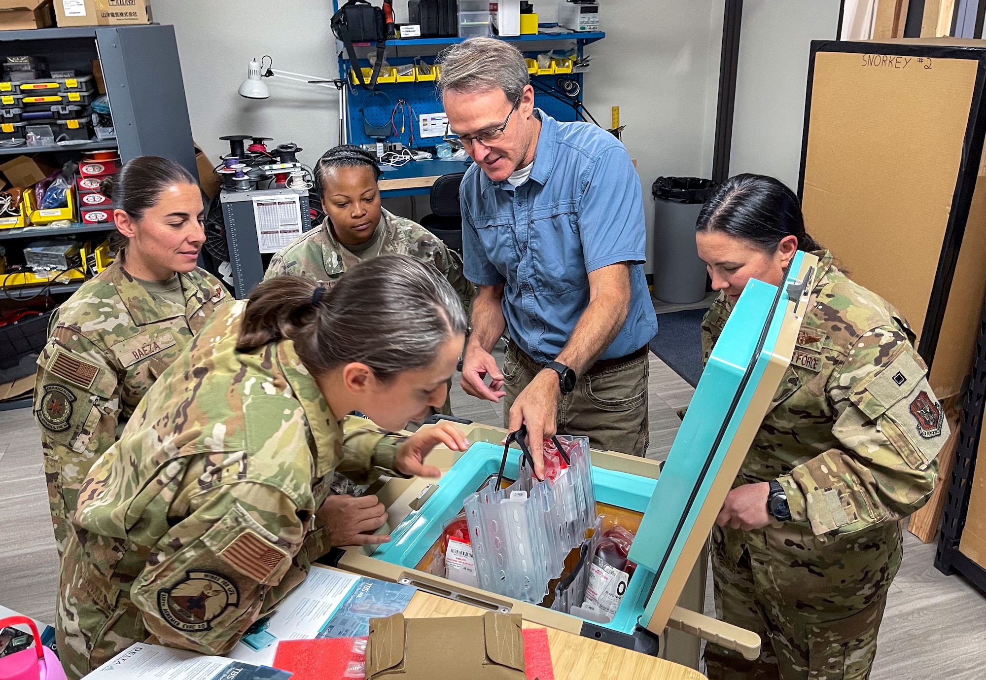 Medical team members get demo of blood storage device.