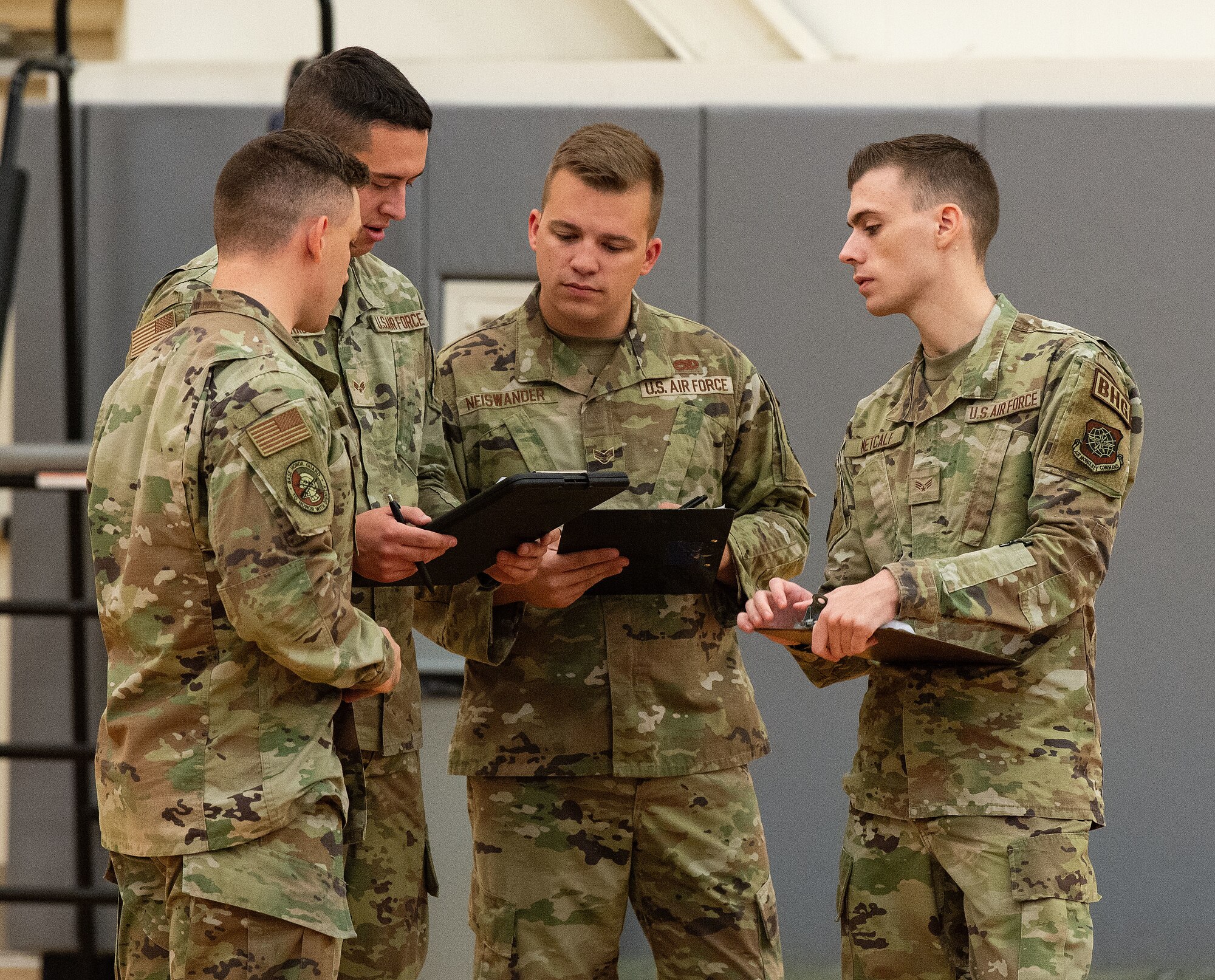 Dover Base Honor Guard trainers discuss notes taken during the first day of tryouts for a U.S. Air Force Honor Guard ceremonial guardsman tasking at Dover Air Force Base, Delaware, Sept. 5, 2024. Seventeen former Dover Base Honor Guard members went through a two-day tryout process for the upcoming presidential inauguration ceremony scheduled in January 2025. (U.S. Air Force photo by Roland Balik)