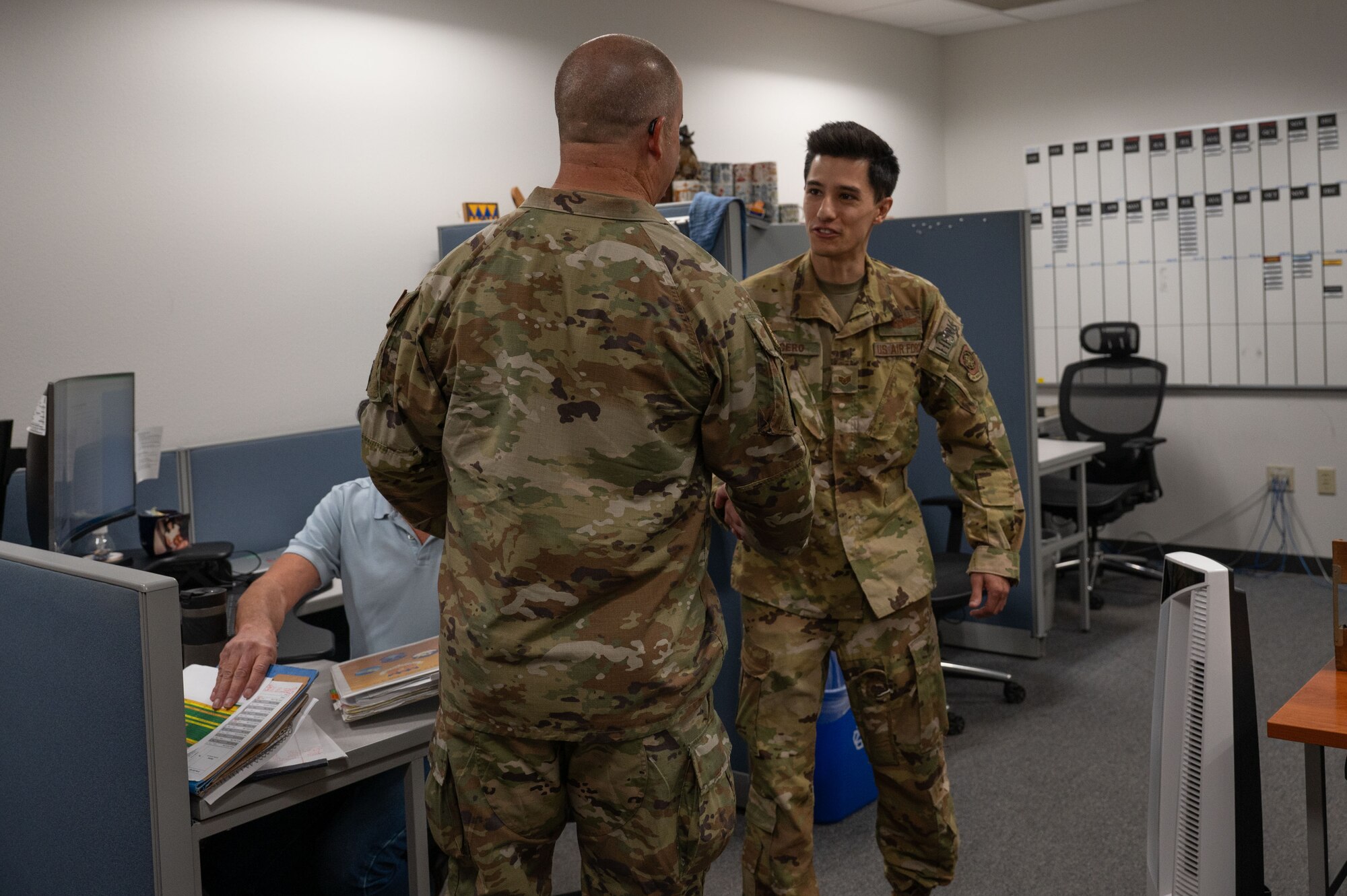 U.S. Air Force Chief Master Sgt. Trapper Otto, command first sergeant for Air Mobility Command, coins Staff Sgt. Robert Lucero, 39th Airlift Squadron evaluator loadmaster, at Dyess Air Force Base, Texas, Oct. 30, 2024. During his visit, Otto toured the 317th Airlift Wing combined maintenance building to greet and present coins to outstanding Airmen. (U.S. Air Force photo by Airman 1st Class Emma Anderson)