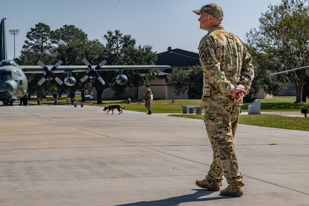 U.S. Air Force Col. Gary Symon, 23rd Wing acting commander, watches a military working dog demonstration at Moody Air Force Base, Georgia, Oct. 28, 2024. The Battlefield Circulation, or immersion, connected leadership with security forces Airmen who demonstrated various aspects of their mission.  (U.S. Air Force photo by Airman 1st Class Savannah Carpenter)