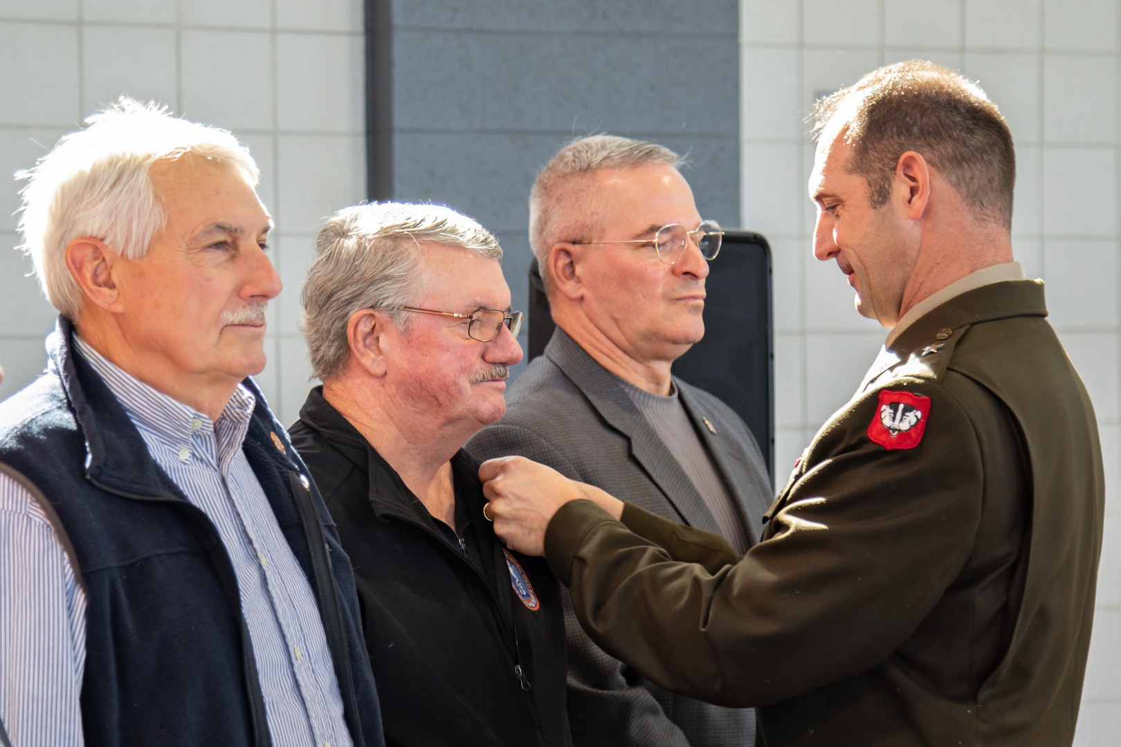 U.S. Army Brig. Gen. Matthew Strub, Wisconsin's deputy adjutant general for Army, recognizes Wisconsin Army National Guard Hall of Honor members with custom lapel pins signifying their significant contribution to the Wisconsin National Guard mission during a Hall of Honor induction ceremony at the Department of Military Affairs facility in Madison, Wisconsin, October 19, 2024. The Hall of Honor program was established in 2000 to recognize the special contributions National Guard members make to the overall success of the Wisconsin National Guard. (U.S. Army National Guard photo by Staff Sgt. Amanda Stock)