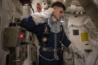 ET3 John Mann acts as a phone talker during damage control training aboard the USS Cole (DDG 67) in the Mediterranean Sea.