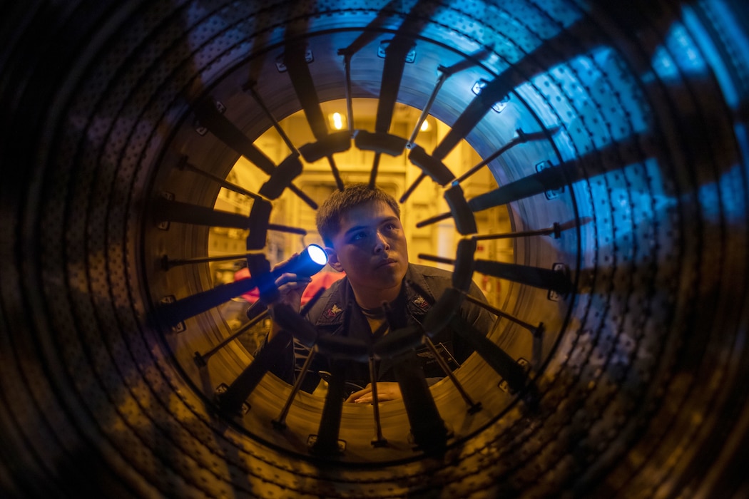 AD2 Julio Loera inspects an F-18E Super Hornet afterburner aboard  USS George Washington (CVN 73) in the Pacific Ocean.