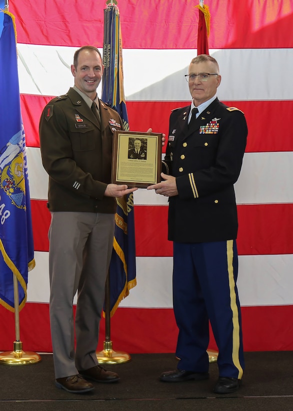 U.S. Army Brig. Gen. Matthew Strub, Wisconsin's deputy adjutant general for Army, inducts retired Col. Jeffrey Paulson into the Wisconsin Army National Guard Hall of Honor at the Department of Military Affairs facility in Madison, Wisconsin, October 19, 2024. The Hall of Honor program was established in 2000 to recognize the special contributions National Guard members make to the overall success of the Wisconsin National Guard. (U.S. Army National Guard photo by Staff Sgt. Amanda Stock)