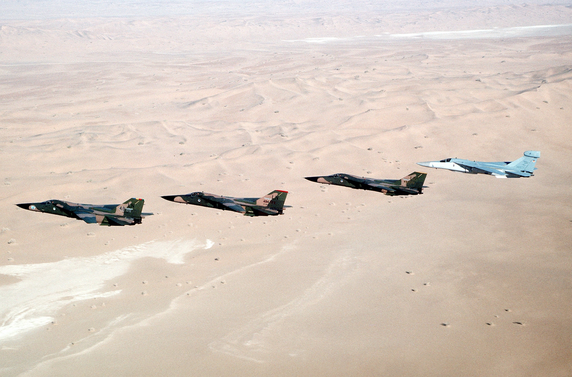 F-111F  is the furthest left F-111 in the formation.