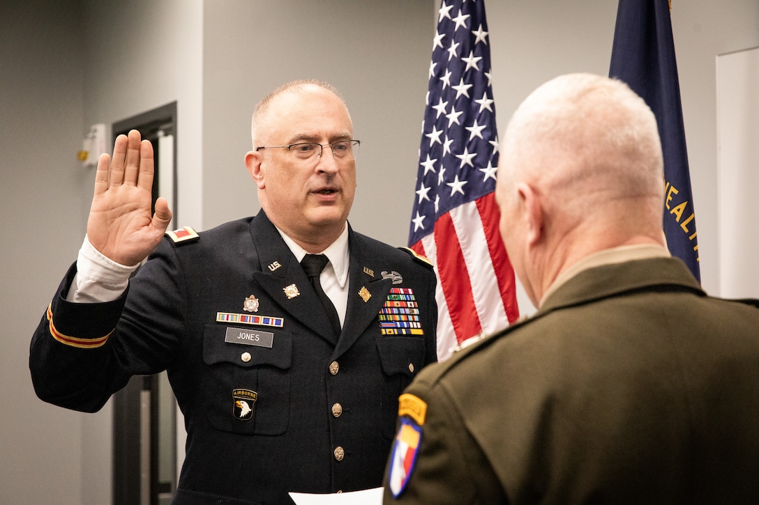 Col. Kevin Jones takes the oath of commission, read by Maj. Gen. Haldane Lamberton