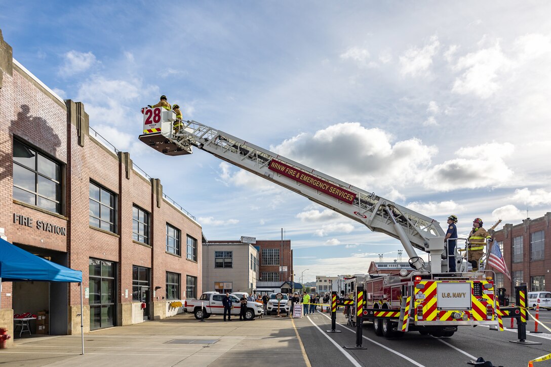 Navy Region Northwest Fire and Emergency Service firefighters conduct a rescue demonstration Oct. 9, 2024, during a National Fire Prevention Week observance outside Building 435 at Puget Sound Naval Shipyard & Intermediate Maintenance Facility in Bremerton, Washington. (U.S. Navy photo by Jeb Fach)