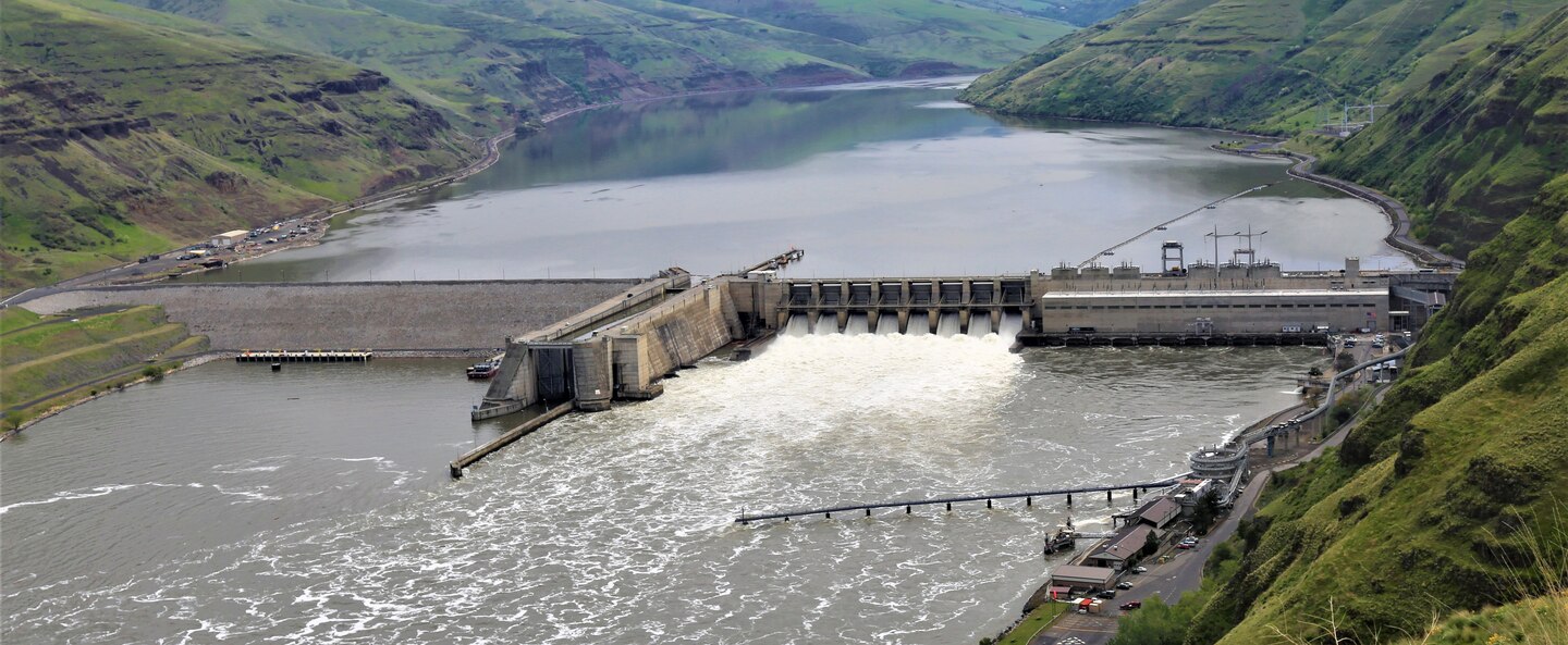 Overhead view of a dam spanning a large river.