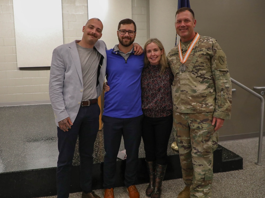 Col. John B. Blackburn poses with his wife, Amy, and two sons, Tanner and Taylor