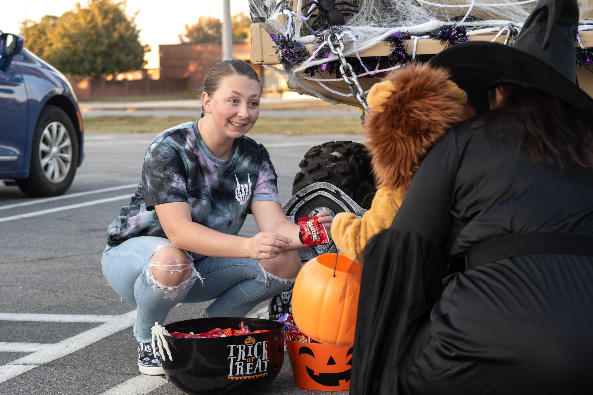 U.S. Air Force Senior Airman Kylie McKinney, 4th Security Forces Squadron assistant unit deployment manager, hands out candy to children during the Halloween Spooktacular and Lead Wing Celebration at Seymour Johnson Air Force Base.
