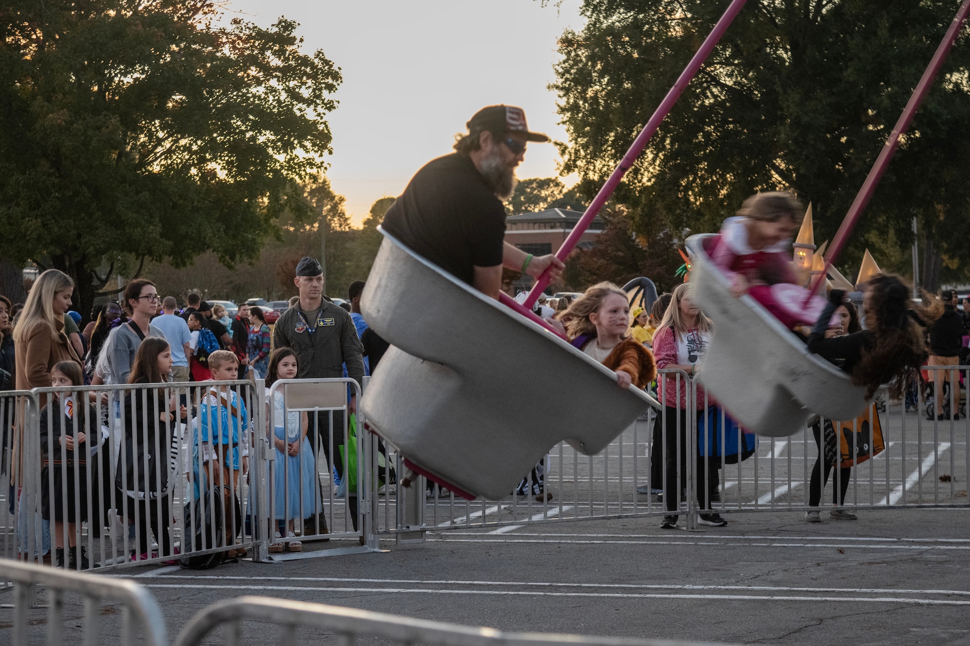 People wait their turn to get on an amusement park ride during the Halloween Spooktacular and Lead Wing Celebration at Seymour Johnson Air Force Base.
