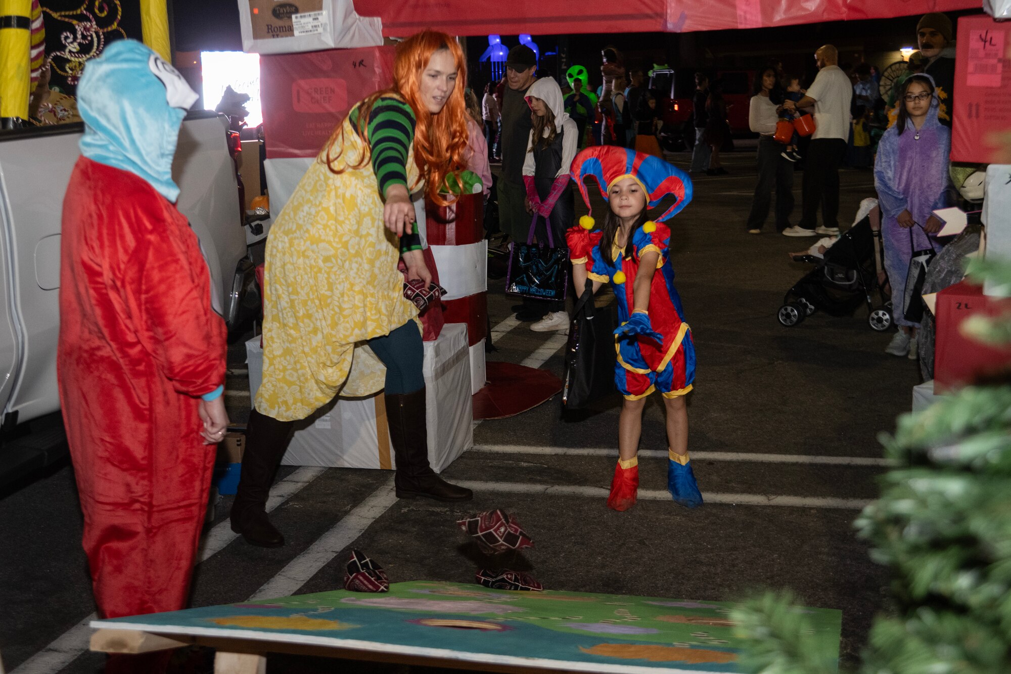 A child participates in a Cornhole game during the Halloween Spooktacular and Lead Wing Celebration at Seymour Johnson Air Force Base.