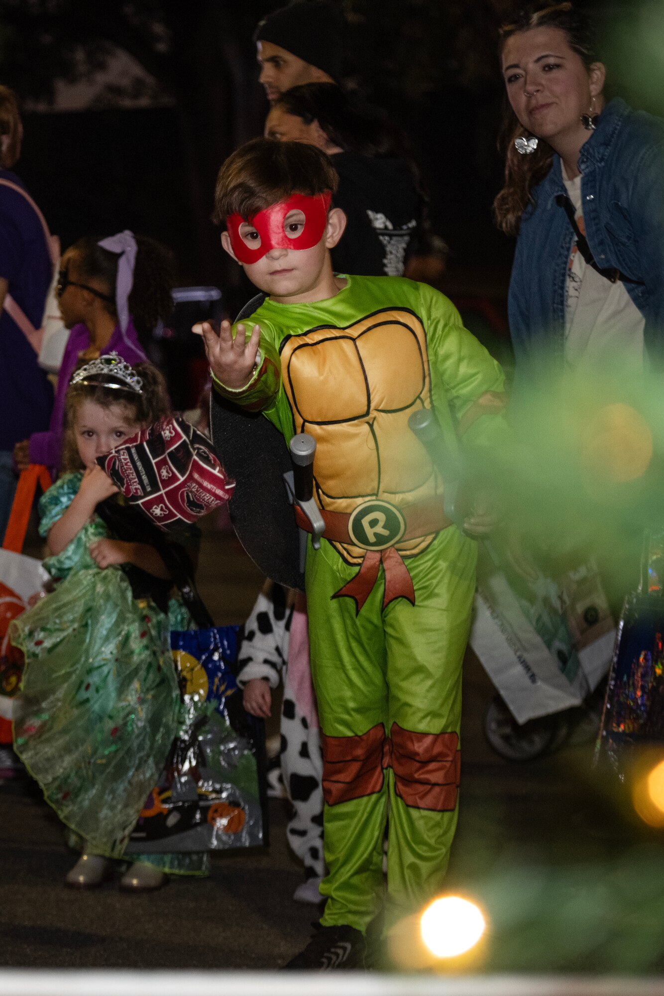 A child participates in a Cornhole game during the Halloween Spooktacular and Lead Wing Celebration at Seymour Johnson Air Force Base.