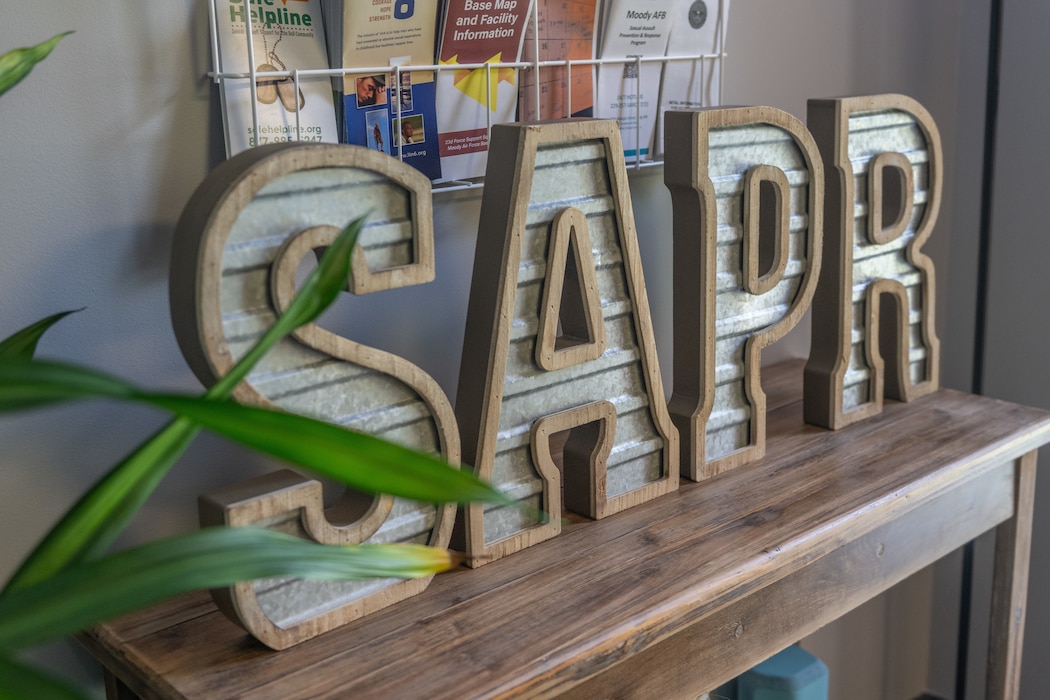 A Sexual Assault Prevention and Response (SAPR) sign is on a table at the new SAPR office at Moody Air Force Base, Georgia, Sept. 19, 2024. The 23rd Wing hosted a grand opening event of the new facility to showcase the privacy improvements and educate Airmen on the SAPR program’s mission. (U.S. Air Force photo by Airman 1st Class Savannah Carpenter)