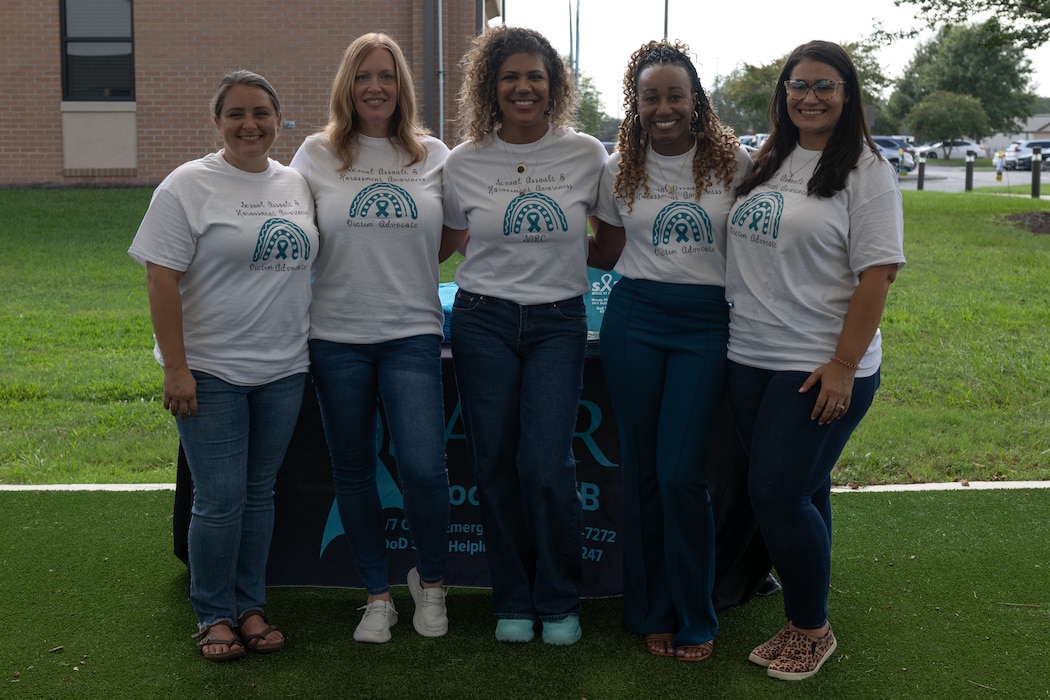 The 23rd Wing Sexual Assault Prevention and Response team poses for a photo at Moody Air Force Base, Georgia, Sept. 19, 2024. The SAPR team hosted a grand opening event of their new facility to spread awareness for their relocation. (U.S. Air Force photo by Airman 1st Class Savannah Carpenter)