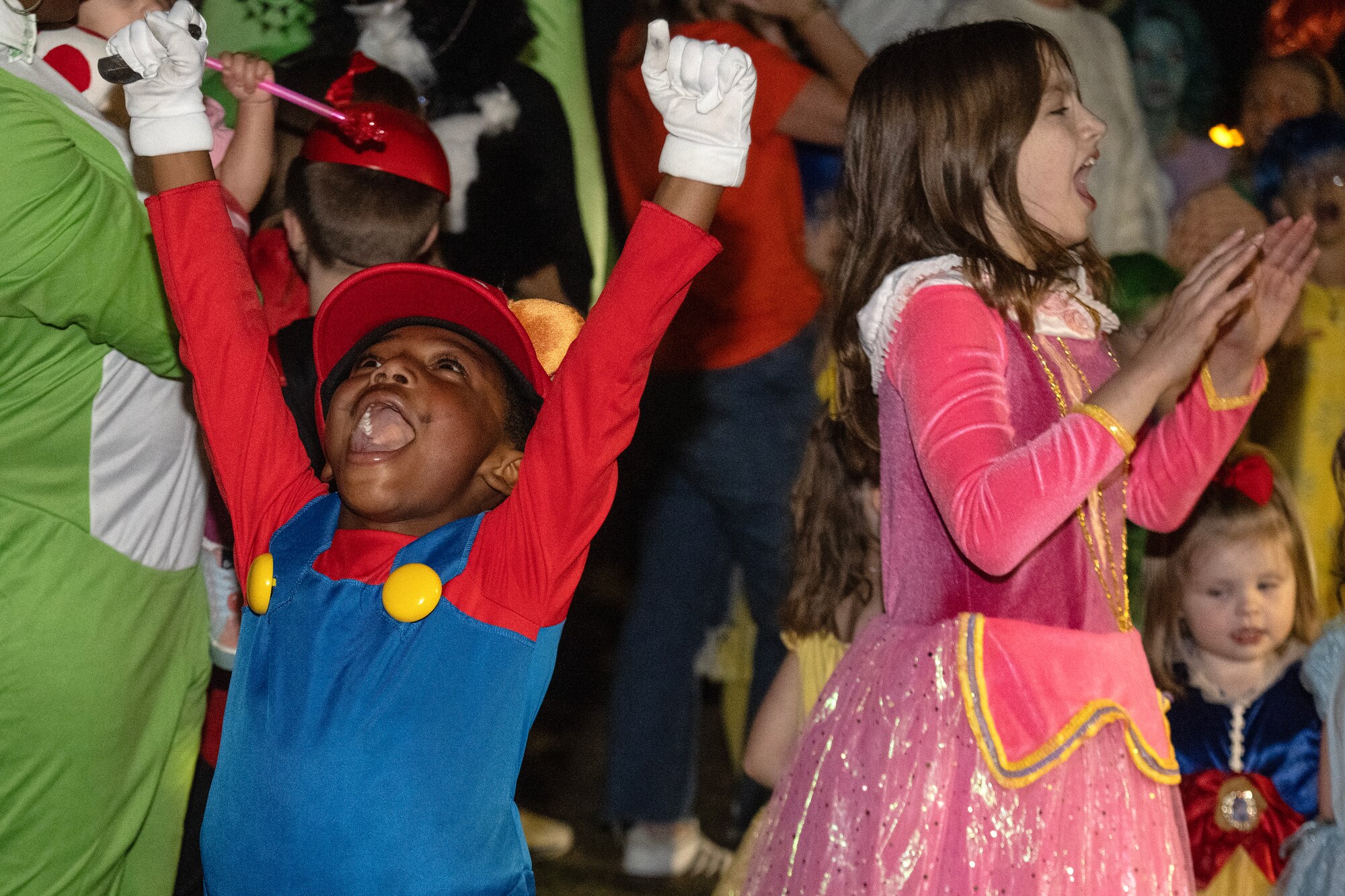 Children cheer and dance to music during a costume contest as part of the Halloween Spooktacular and Lead Wing Celebration at Seymour Johnson Air Force Base.
