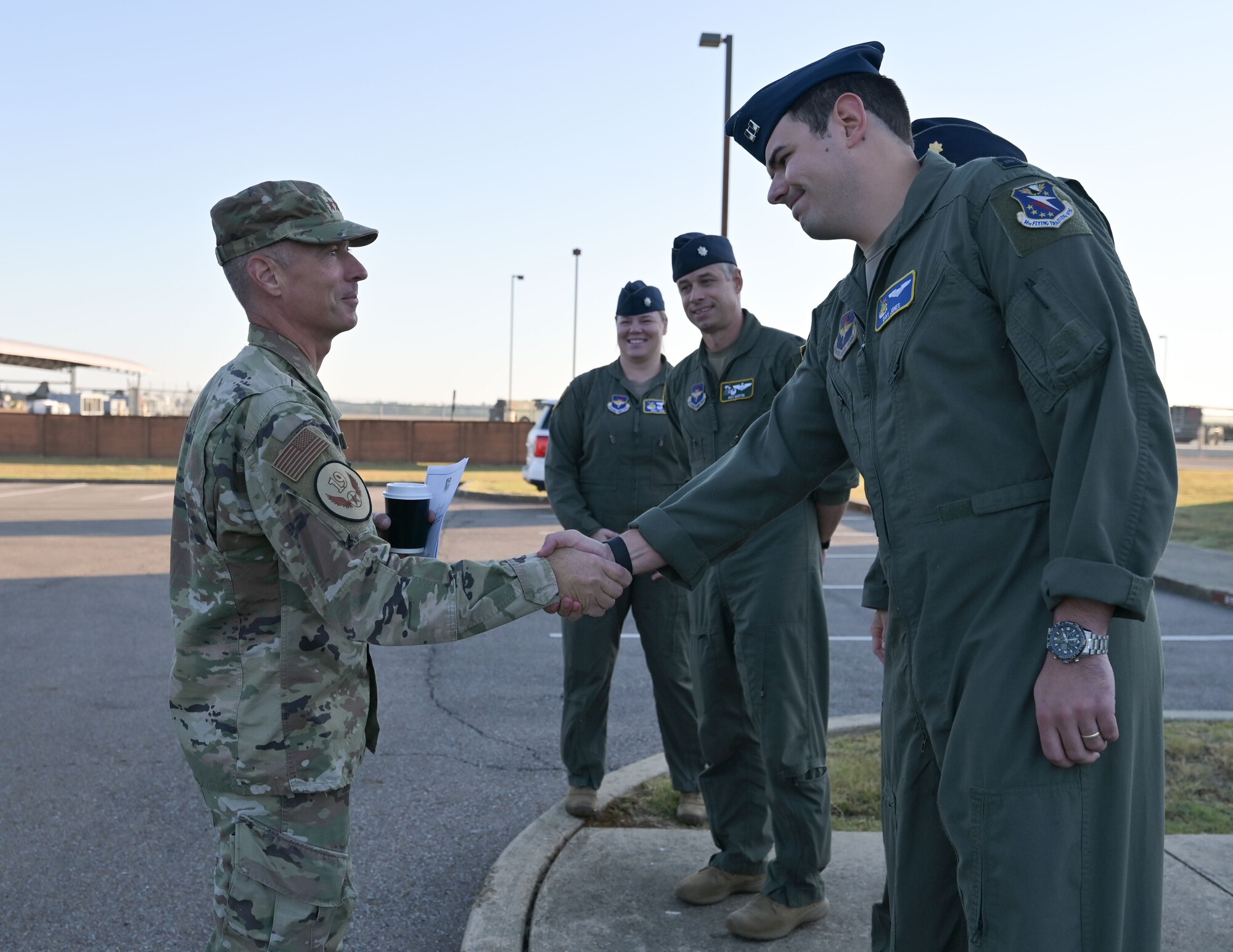 Maj. Gen. Kreuder shakes hands with instructor pilot.