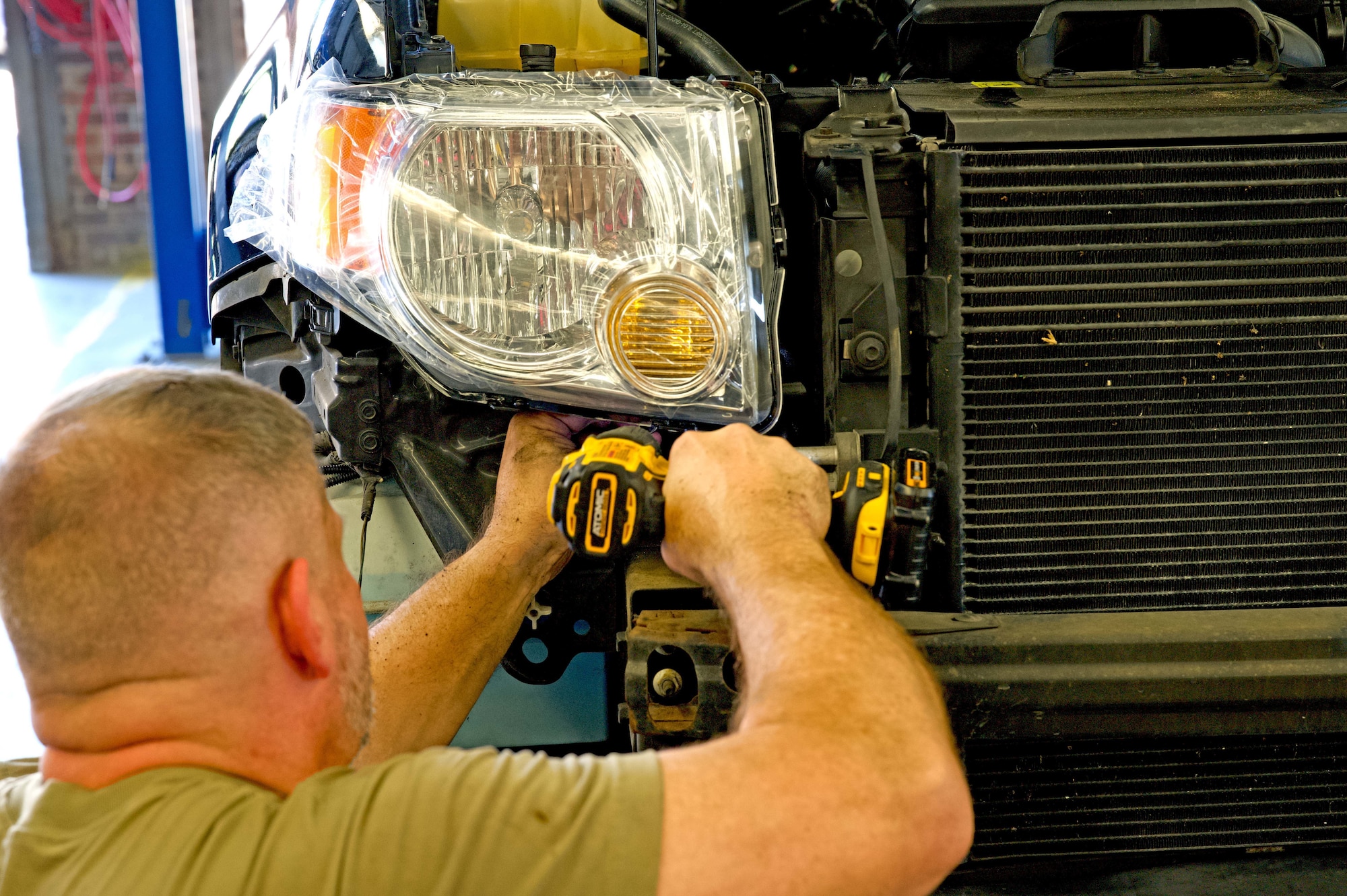 Airman conducts car maintenance