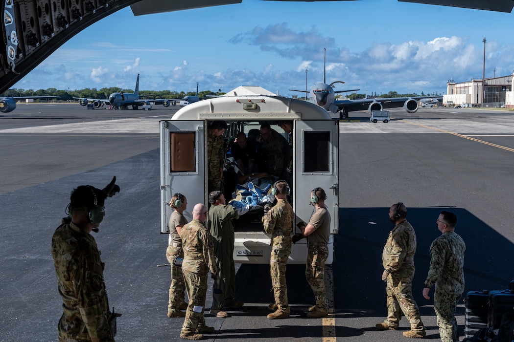 Airmen offload a patient from an ambulance onto a C-17