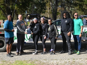 A group of people pose outside.