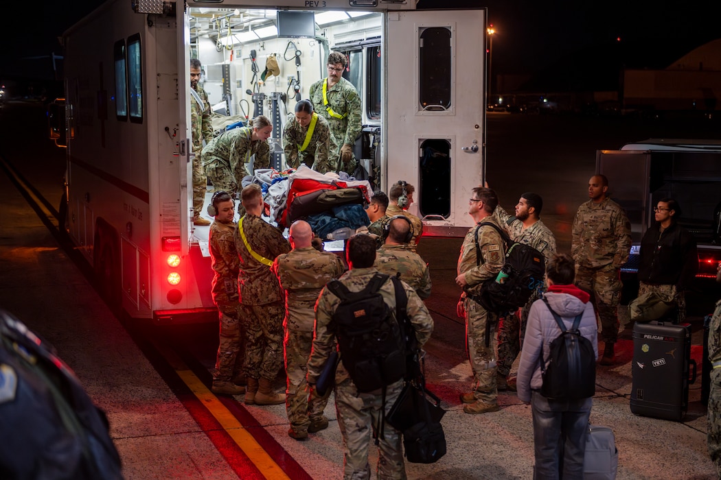 Airmen load a patient to an ambulance from a C-17