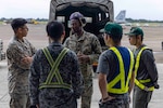 Aircraft fuel specialists discuss operations on flightline