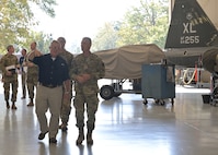 Kreuder walks with maintenance in hangar.