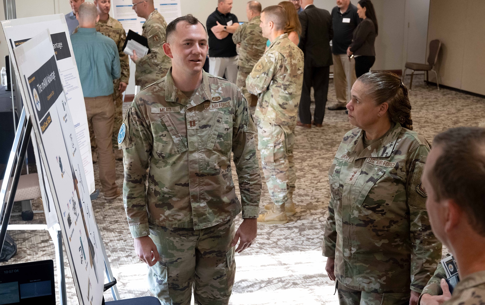 Two Airmen speak together.