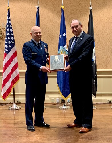 Brig. Gen. Joesph L. Sheffield, Jeanne M. Holm Center for Officer Accessions and Citizen Development commander, presents retired Lt. Gen. David Deptula the 2024 Holm Center distinguished alumni placard.