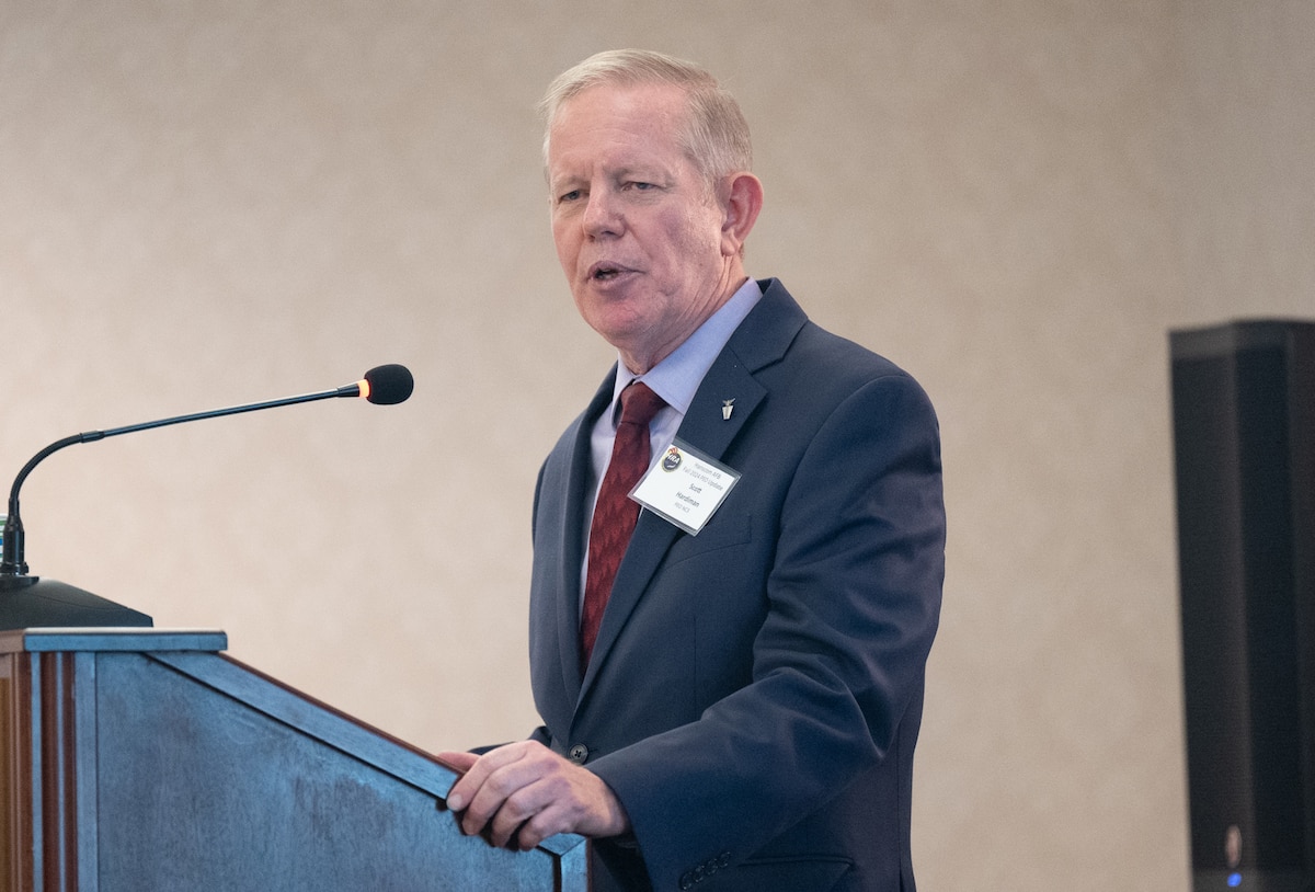 Image of person speaking at podium.