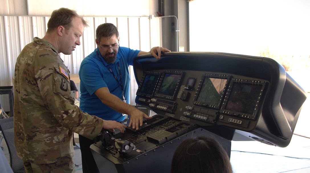 During a tour of a U.S. defense contractor's test site conducted Sept. 16, 2024, at Yuma Proving Ground, Arizona, Army Maj. David L. Rasmussen, innovation officer with Detachment E, Army Applications Group, 75th U.S. Army Reserve Innovation Command, learns about the functions and capabilities of a prototype instrumental panel designed to control multiple unmanned aerial vehicles.