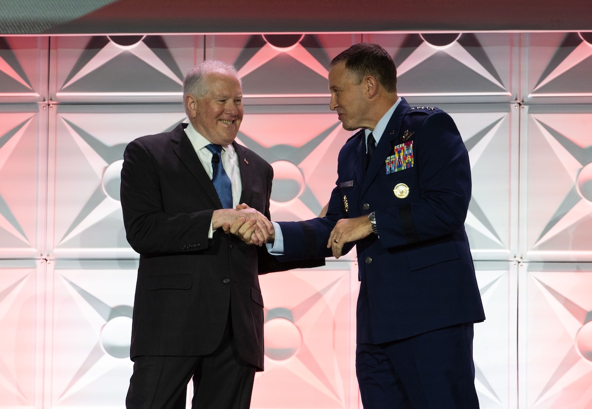 Secretary of the Air Force Frank Kendall shakes hands with U.S. Air Force Gen. Johnny Lamontagne, Air Mobility Command commander, during the 56th Annual Airlift/Tanker Association Symposium, Nov. 1, 2024, Grapevine, Texas. Kendall discussed the U.S. Air Force's efforts to reoptimize for Great Power Competition and the need to modernize the force to better posture the Department of Defense to more effectively deter China. Summer 2025 stands as a testing ground for reoptimization as the Air Force and Air Mobility Command conduct major exercises in the Pacific, including Resolute Force Pacific (REFORPAC), Mobility Guardian 2025, and several others. (U.S. Air Force photo by Staff Sgt. Dalton Williams)