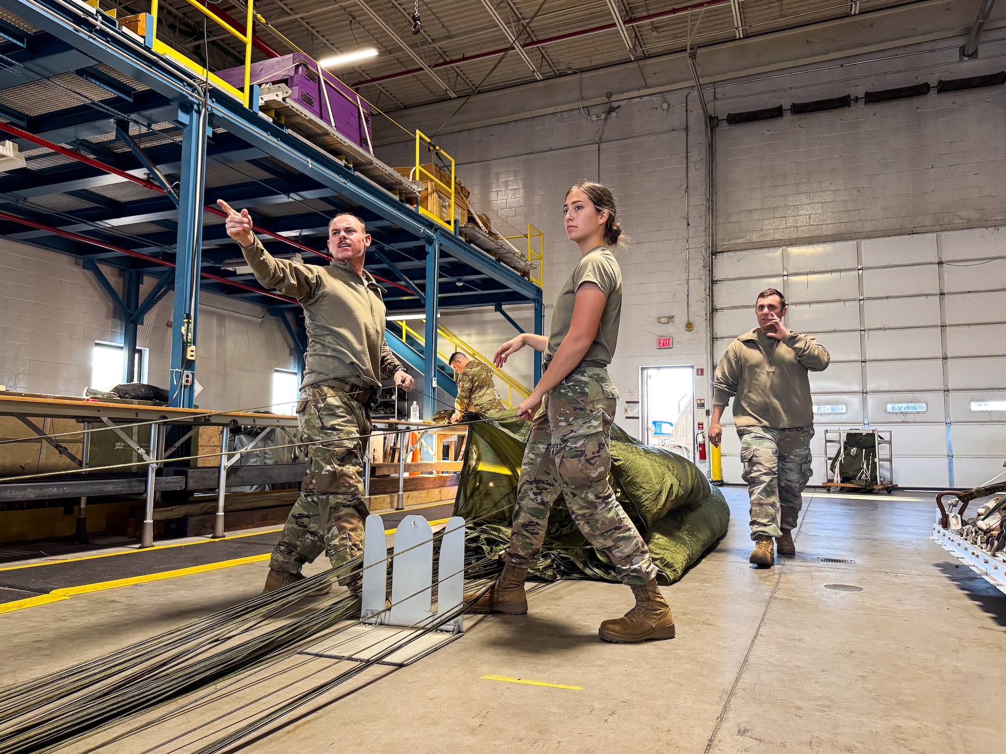 Under the supervision of qualified riggers, Airmen in the air transportation specialist career field from the 193rd Special Operations Logistics Readiness Squadron take part in rigging parachutes for training airdrops using the wing’s new MC-130J Commando II aircraft, Nov. 2, 2024.