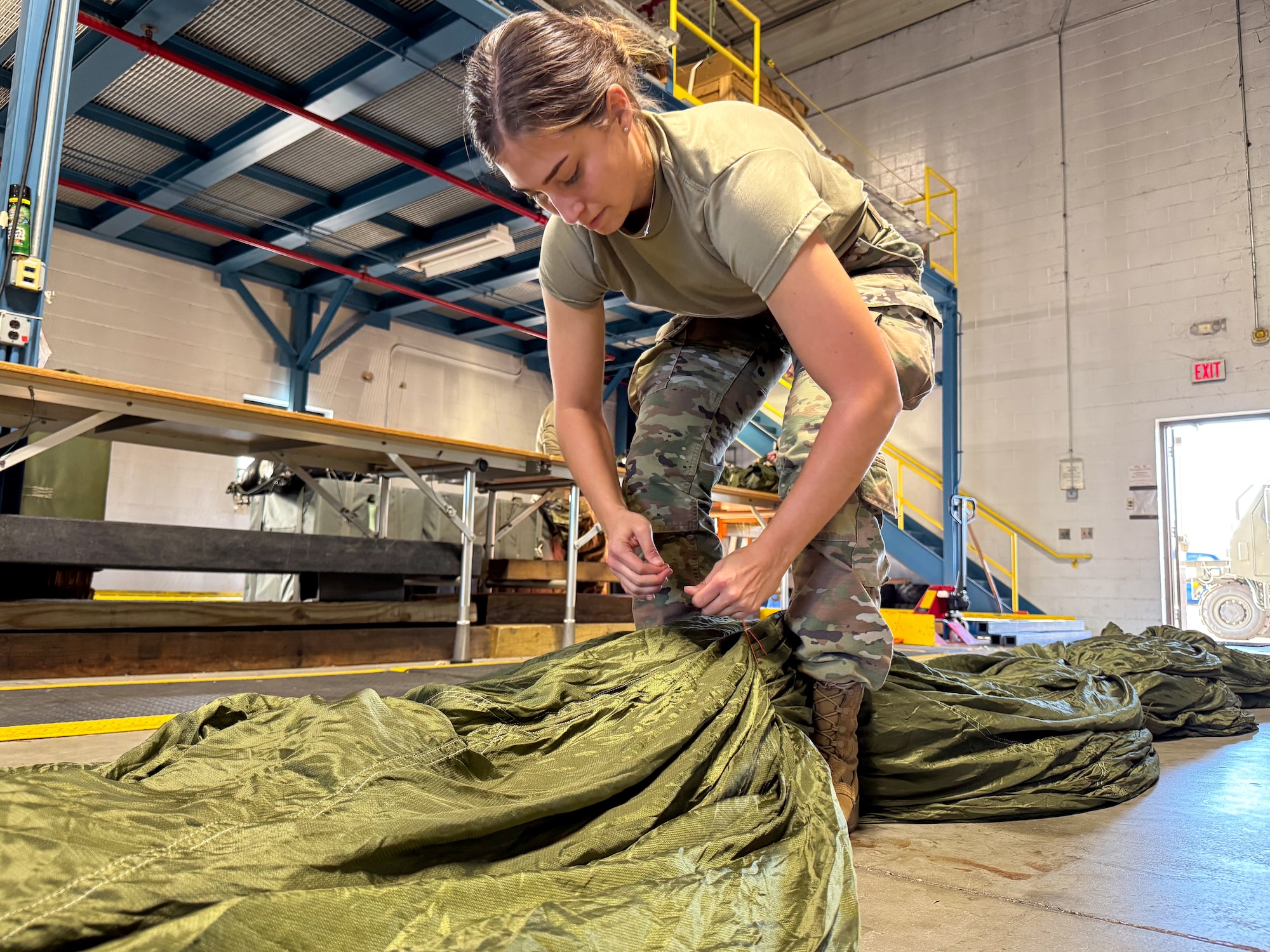 Under the supervision of qualified riggers, Airmen in the air transportation specialist career field from the 193rd Special Operations Logistics Readiness Squadron take part in rigging parachutes for training airdrops using the wing’s new MC-130J Commando II aircraft, Nov. 2, 2024.
