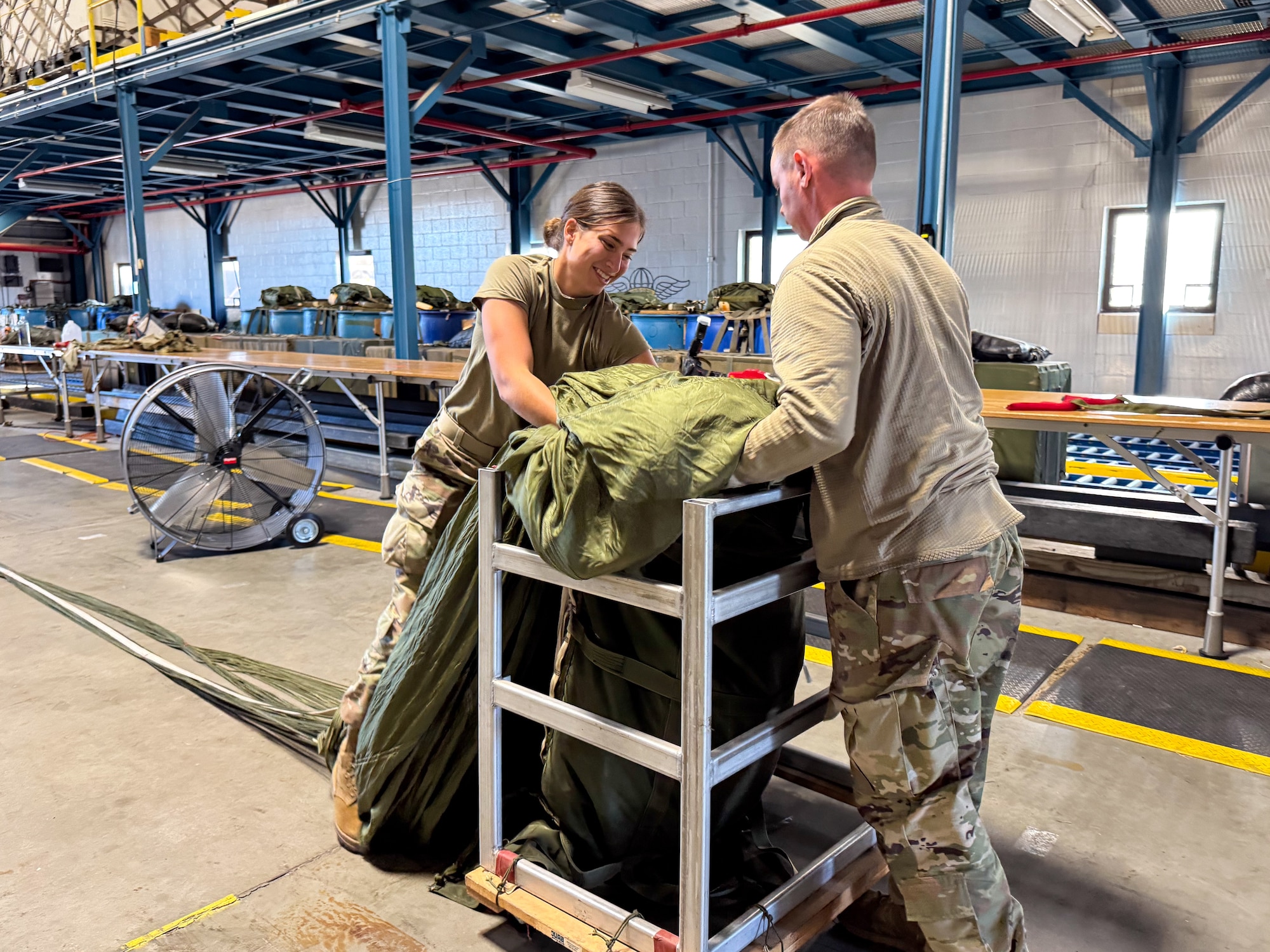 Under the supervision of qualified riggers, Airmen in the air transportation specialist career field from the 193rd Special Operations Logistics Readiness Squadron take part in rigging parachutes for training airdrops using the wing’s new MC-130J Commando II aircraft, Nov. 2, 2024.
