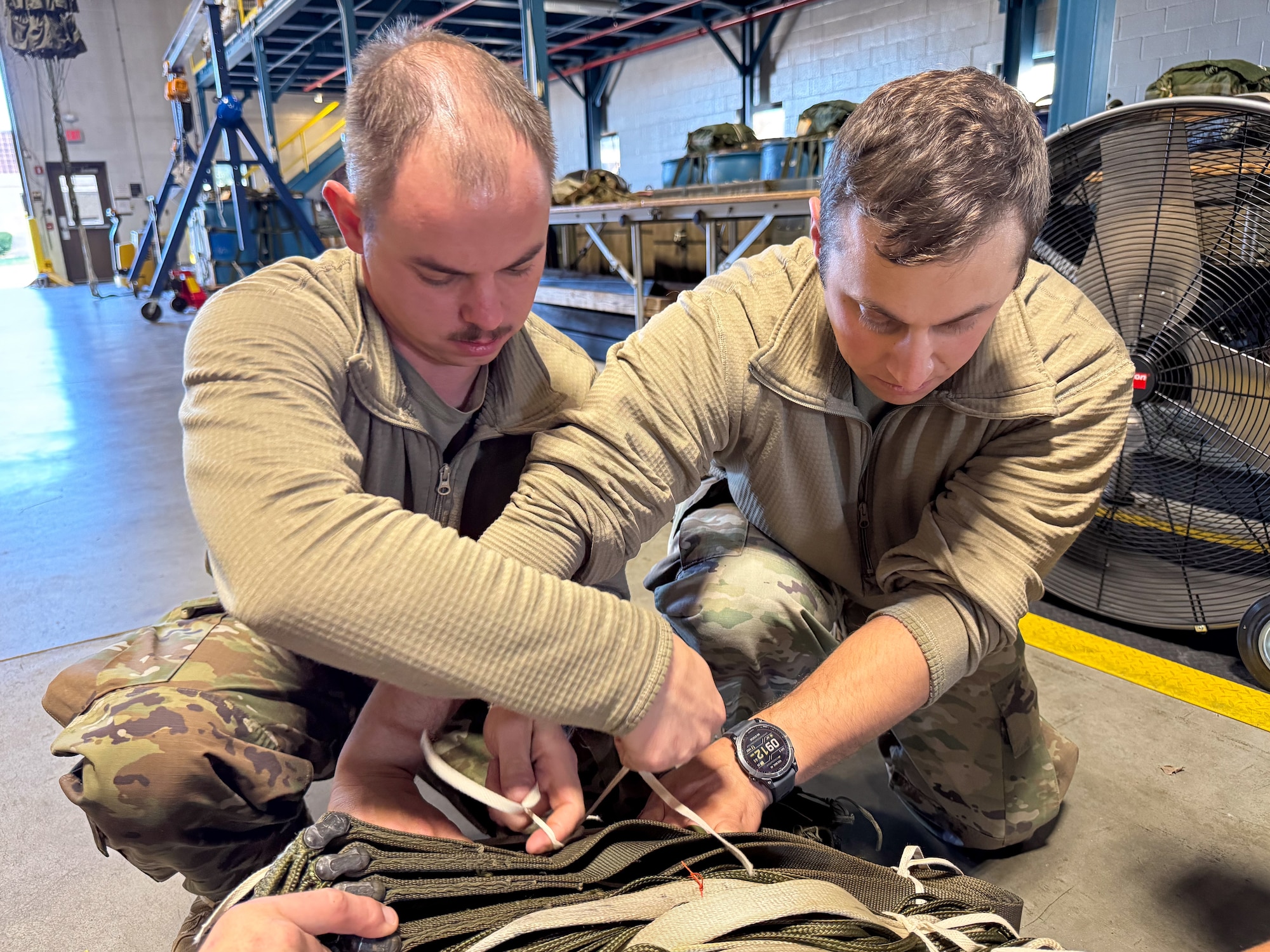 Under the supervision of qualified riggers, Airmen in the air transportation specialist career field from the 193rd Special Operations Logistics Readiness Squadron take part in rigging parachutes for training airdrops using the wing’s new MC-130J Commando II aircraft, Nov. 2, 2024.