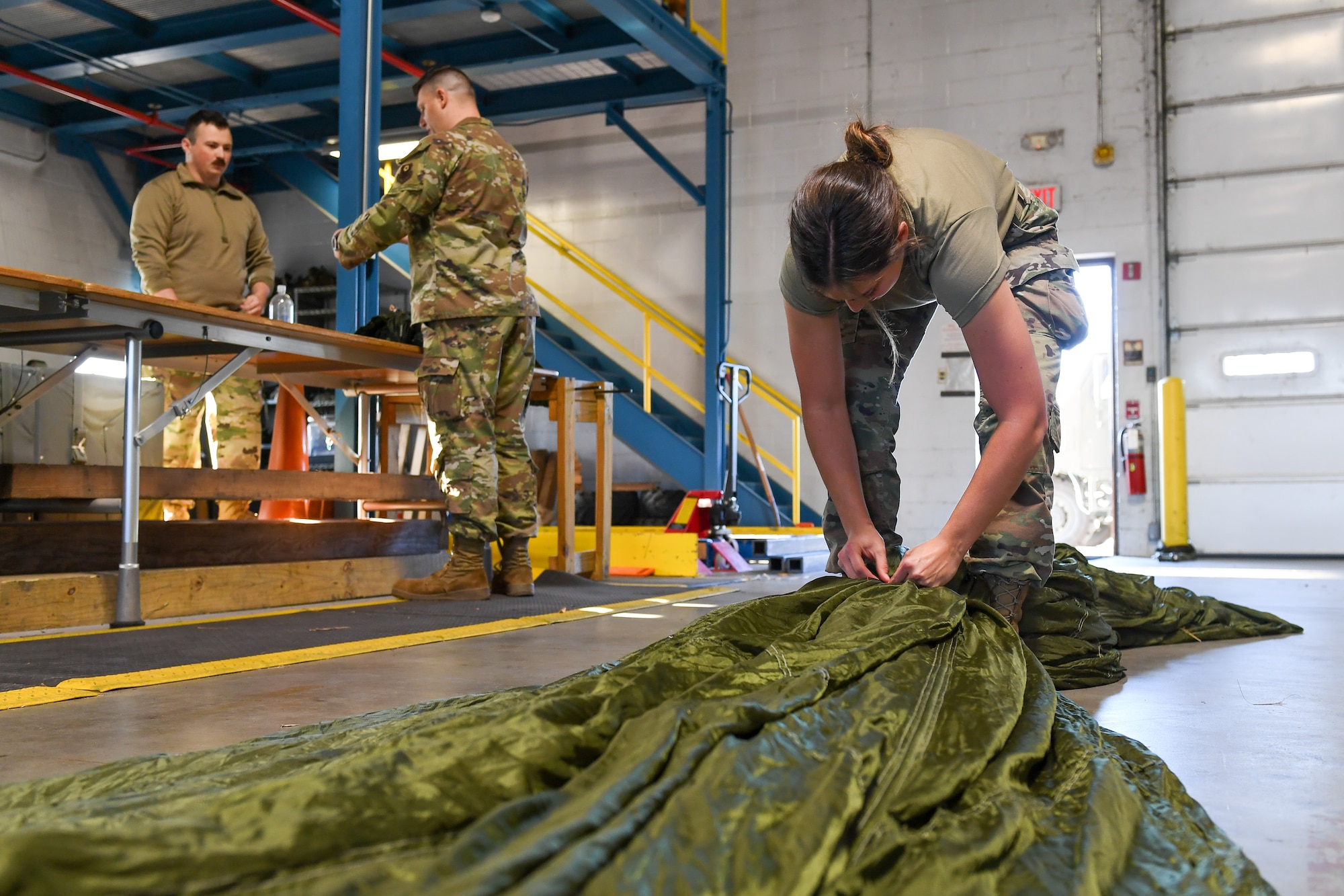 Under the supervision of qualified riggers, Airmen in the air transportation specialist career field from the 193rd Special Operations Logistics Readiness Squadron take part in rigging parachutes for training airdrops using the wing’s new MC-130J Commando II aircraft, Nov. 2, 2024.