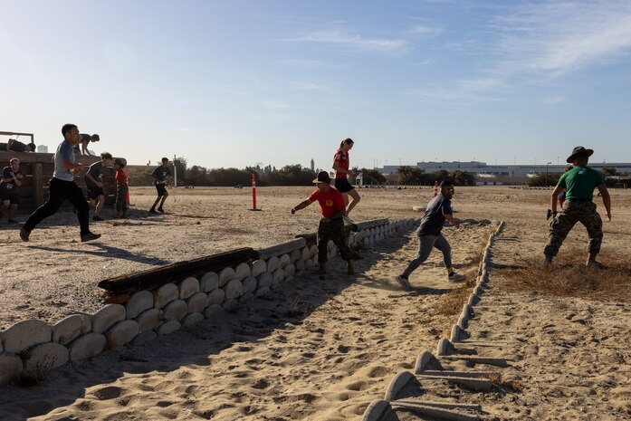 U.S. Marine Corps drill instructors, Recruit Training Regiment, Marine Corps Recruit Depot San Diego, encourage a contestant during the 2024 MCRD San Diego Boot Camp Challenge, Oct. 19, 2024. For the past 23 years, MCRD San Diego has hosted the bootcamp Challenge, a three-mile obstacle course race guided by 60 drill instructors that highlights the physical and mental demands of bootcamp. The event fosters camaraderie and community engagement through interaction with MCRD personnel. (U.S. Marine Corps photo by Lance Cpl. Jacob Hutchinson)