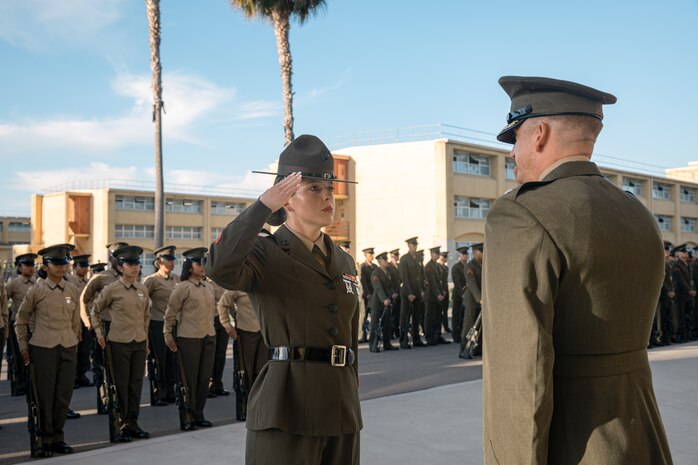 U.S. Marine Corps Staff Sgt. Savannah Pizano, a senior drill instructor with Lima Company, 3rd Recruit Training Battalion, reports to Lt. Col. Matthew Phelps, the commanding officer of 3rd Recruit Training Battalion, for a battalion commander inspection at Marine Corps Recruit Depot San Diego, California, Oct. 23, 2024. The Battalion Commander’s Inspection surveys new Marines for knowledge, bearing, and attention to detail as one of their last tests before graduating. (U.S. Marine Corps photo by Cpl. Sarah M. Grawcock)