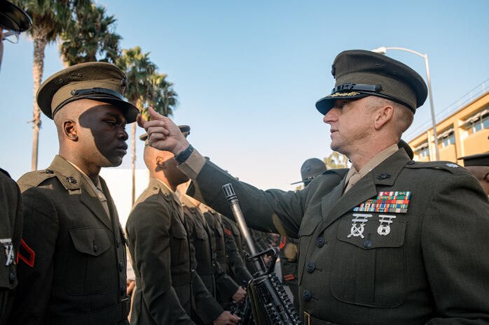 U.S. Marine Corps Lt. Col. Matthew Phelps, the commanding officer of 3rd Recruit Training Battalion, inspects Pfc. Arion Mckinley with India Company, 3rd Recruit Training Battalion during a battalion commander inspection at Marine Corps Recruit Depot San Diego, California, Oct. 23, 2024. The Battalion Commander’s Inspection surveys new Marines for knowledge, bearing, and attention to detail as one of their last tests before graduating. (U.S. Marine Corps photo by Cpl. Sarah M. Grawcock)
