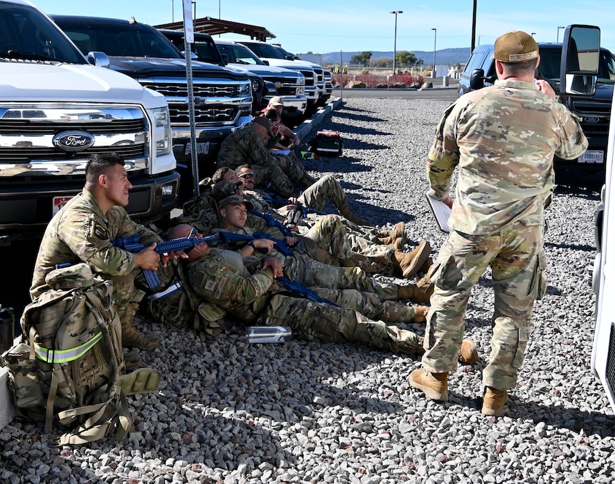 Airman sitting down and being briefed