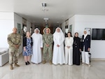 Group of men and women pose for photo.