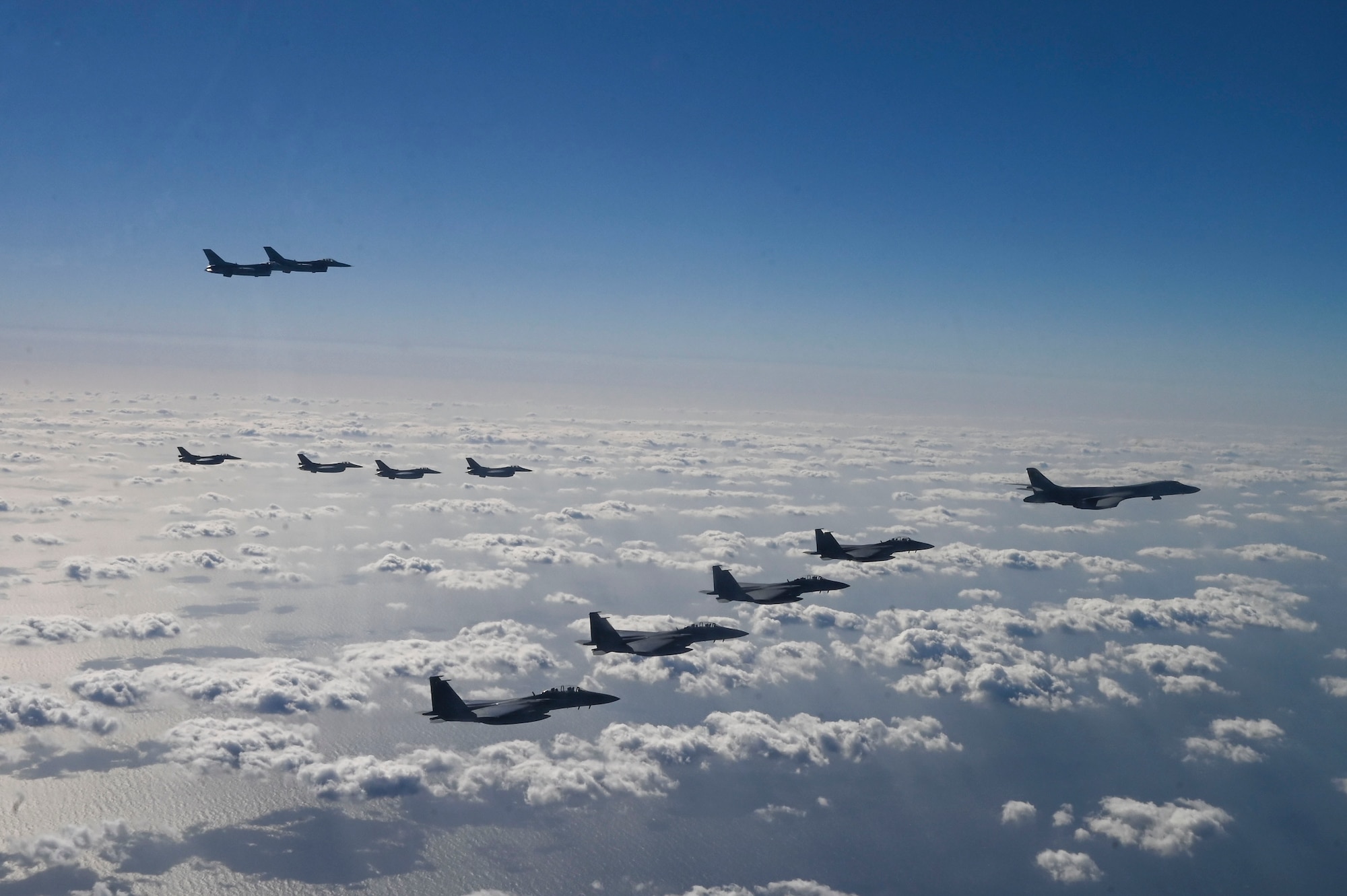 Fighter aircraft from the U.S., Japan, and the Republic of Korea conduct a trilateral escort flight of U.S. bombers operating in the Indo-Pacific, Nov. 3, 2024. Two U.S. F-16 from the 36th Fighter Squadron, 51st Fighter Wing flew with four Japan Air Self-Defense Force F-2s from the 8th Air Wing and four Republic of Korea Air Force F-15Ks from the 11th Fighter Wing to escort one U.S. Air Force B-1B Lancer. (U.S. Air Force photo by Senior Airman Maria Umanzor Guzman)